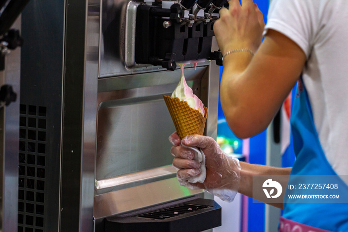 Preparation of creamy fruit ice cream from ice cream machine in shopping mall