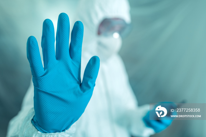 Epidemiologist gesturing stop hand sign in coronavirus concept