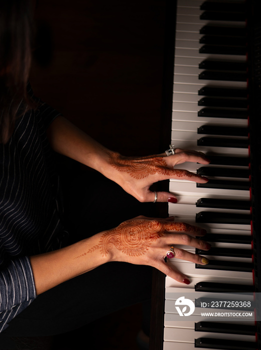 Womans hands playing the piano