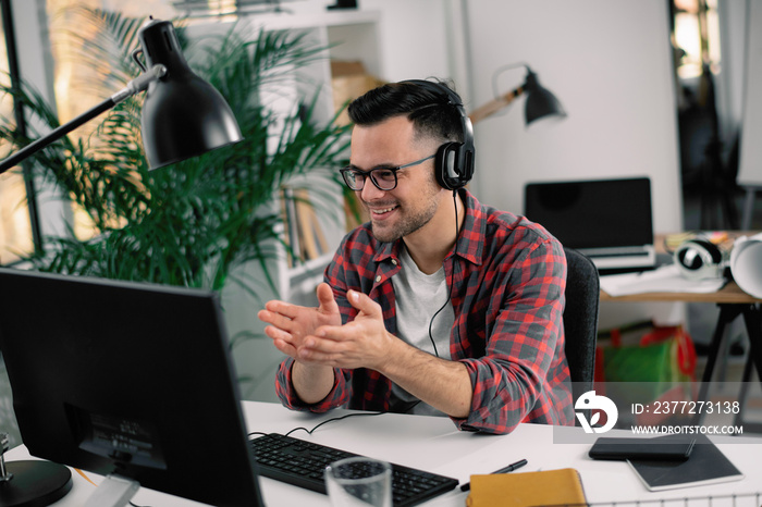 Businessman on video call. Handsome man in office with headphones.