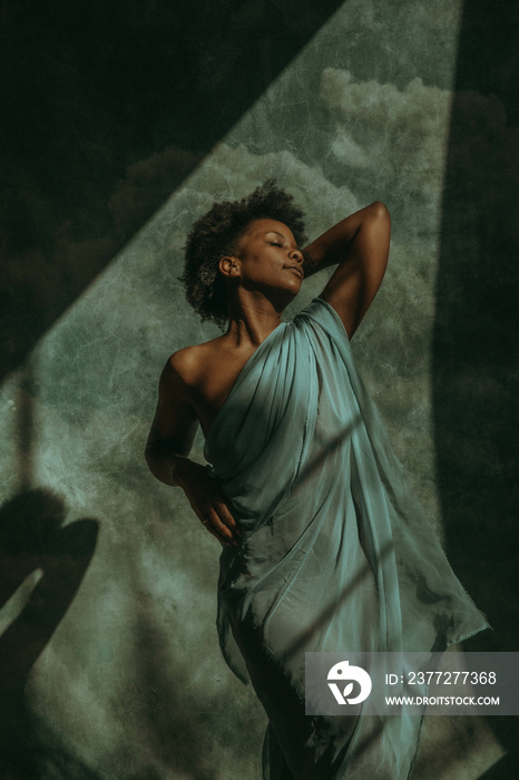 African American woman with afro stretching in the sun