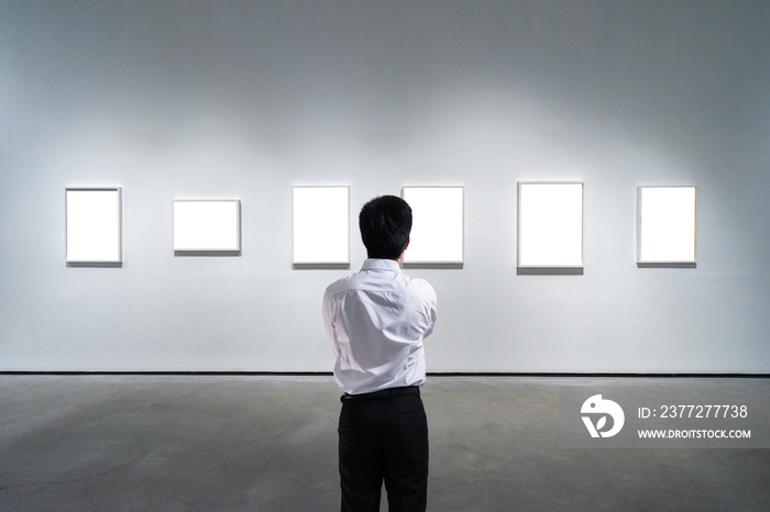 businessman standing in front of wall