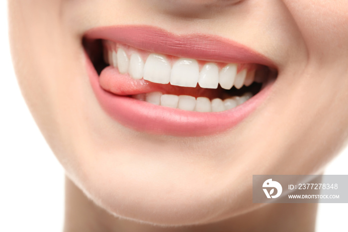 Beautiful young woman with healthy teeth on white background