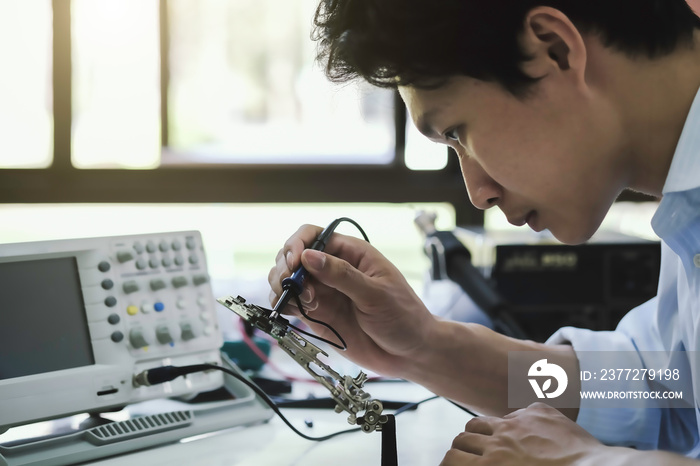 Close up of the hand men hold tool repairs electronics manufacturing Services, Manual Assembly Of Ci