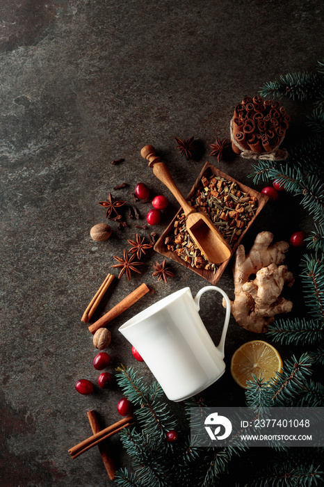 White mug and ingredients for making a winter hot drink on vintage background.