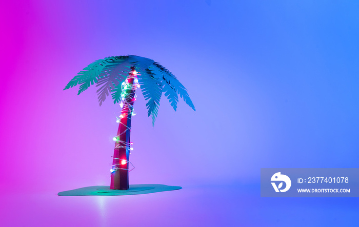 Neon Palm tree with Christmas lights. Minimal New Year concept.