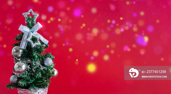 Christmas tree with silver ornaments on red background. Christmas and new year concept.