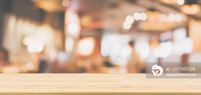 Wood table top with Restaurant cafe or coffee shop interior with people abstract defocused blur back