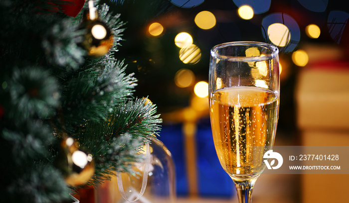 Glass Of Champagne Beside Christmas Tree. Close Up Shot