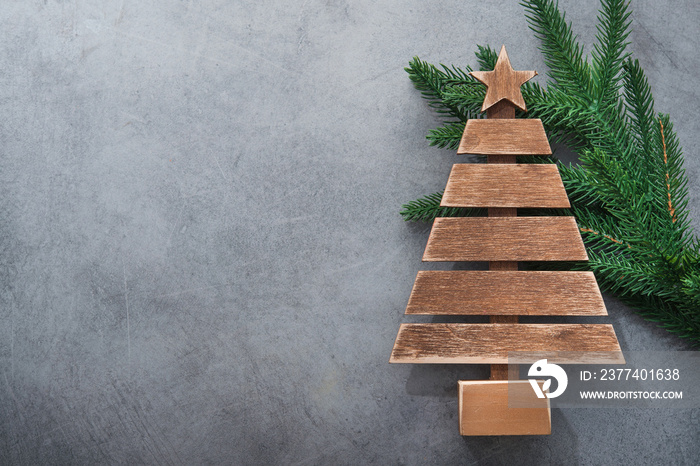 Decor wooden fir tree with branches on a stone background