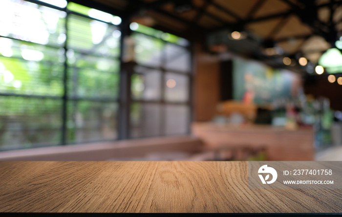 Empty dark wooden table in front of abstract blurred bokeh background of restaurant . can be used fo