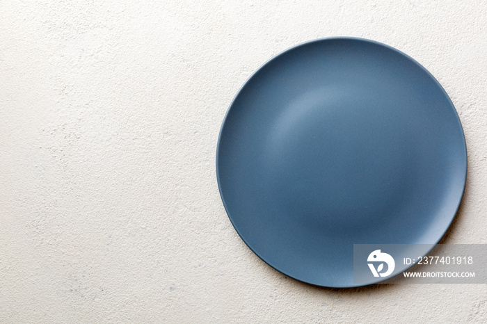 Top view of empty grey plate on cement background. Empty space for your design