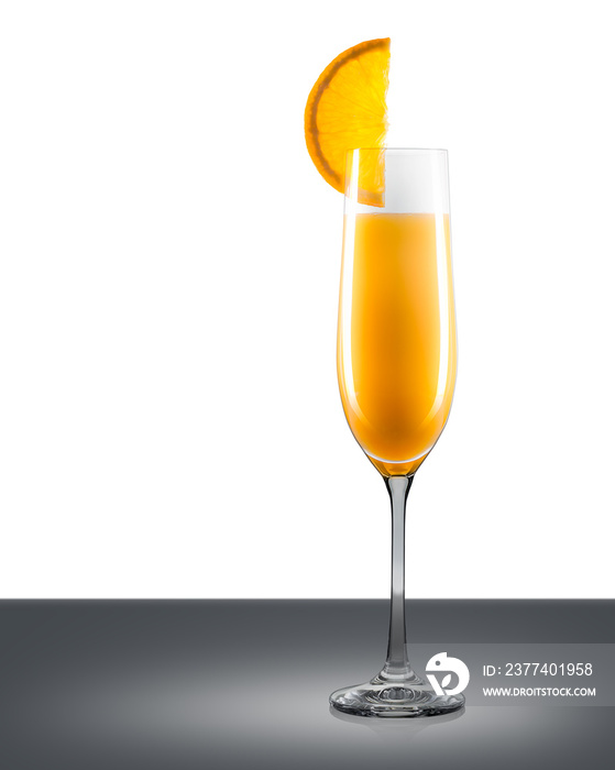 Mimosa cocktail in champagne glass with slice of orange on mirror table and place for inscription. C