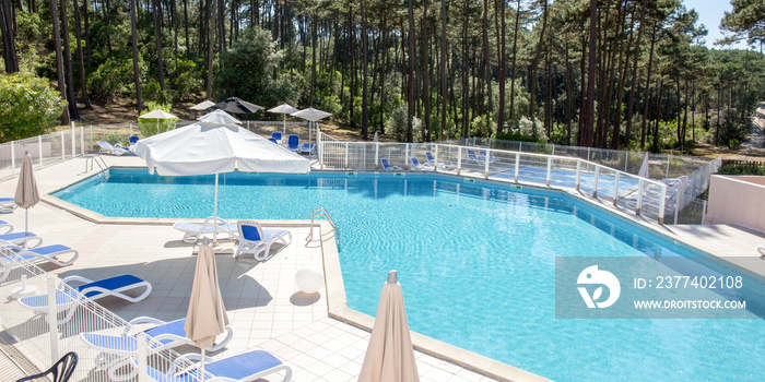 large swimming pool in summer forest with nobody