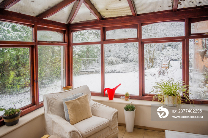 Conservatory with snow in garden outside