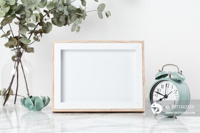 Poster frame mockup, front view, with decor elements, flowers and blank copy space over the white wa