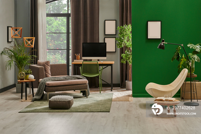 Modern living room with grey sofa and frame, green wall close up decoration in front of the window.