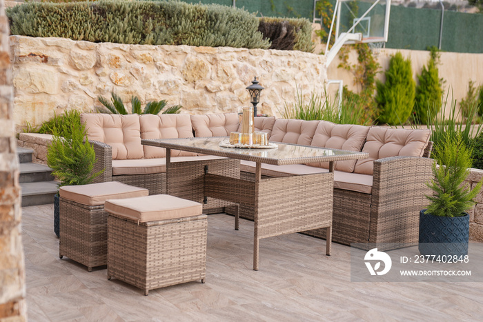 Modern garden furniture of rattan inside the patio of the house,beige