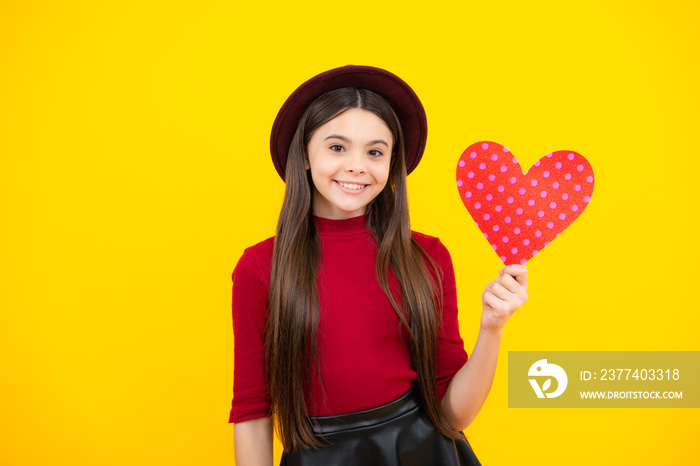 Happy teenager portrait. Young teenager child girl with heart shape. Happy Valentines Day. Love and 