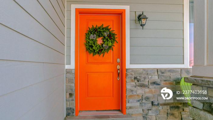 Clear Panorama Home with a welcoming wreath hanging on the orange front door