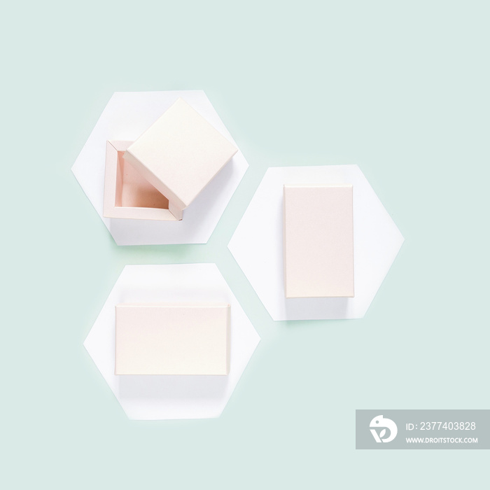 Festive neo mint flat lay. Set of gift boxes on white hexagons hexagons on a neo mint background, bi