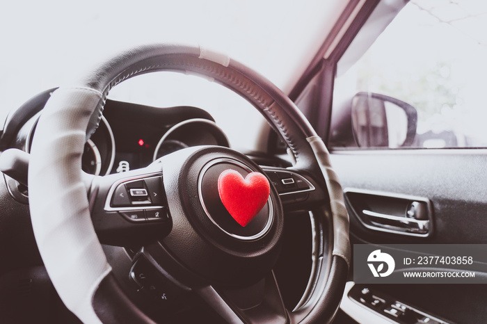 Steering wheel with heart red object.Love car concept idea.interior console car.