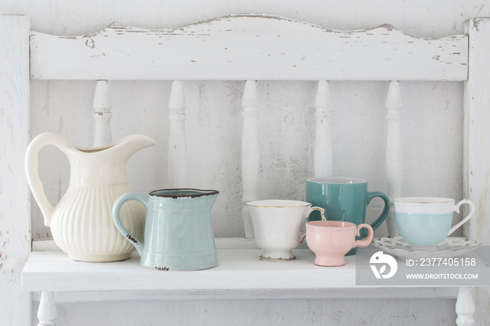 dinnerware on white wooden shelf