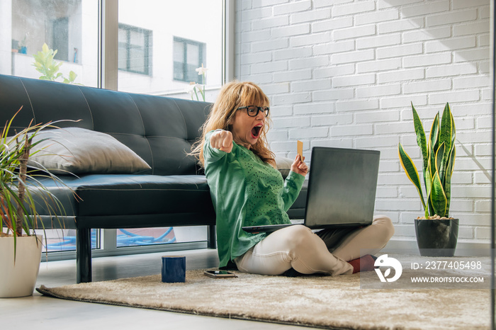 woman excited with joy at home buying online