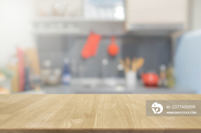 Wood table top and blurred kitchen interior background with vintage filter - can used for display or