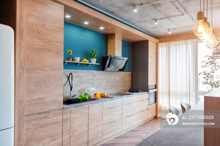 Modern furniture in luxury kitchen. Minimalist scandinavian interior in loft apartment with wooden f