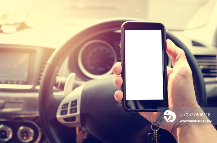 hand holding phone with white screen in car