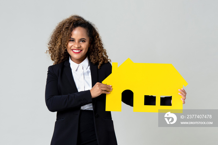 Happy agent holding yellow house