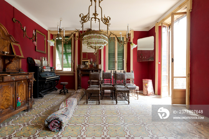 Front view of living room with leather chairs, rugs and red walls