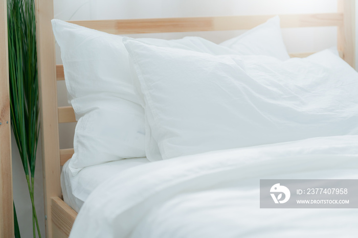 Bed maid-up with clean white pillows and bed sheets in beauty bedroom. Close-up. interior background