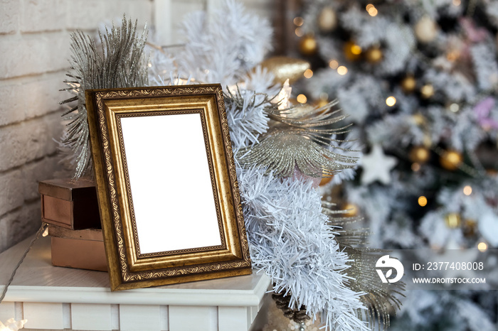 Empty blank photo frame in christmas decorated defocused background with toys lights