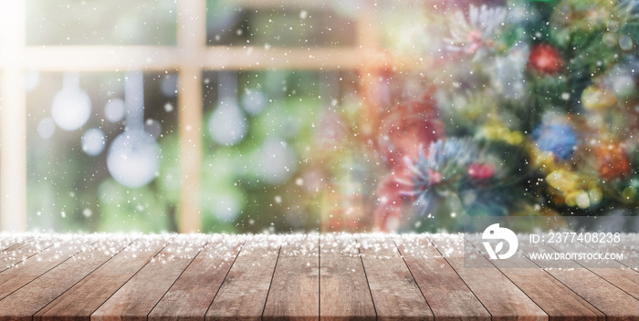 Empty wood table top on blur with bokeh Christmas tree and news year decoration on window banner ba