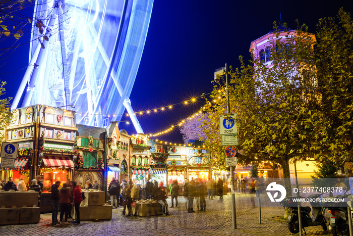 Night colorful atmosphere of Weihnachtsmarkt, Christmas market, in Düsseldorf, the ferris wheel and 