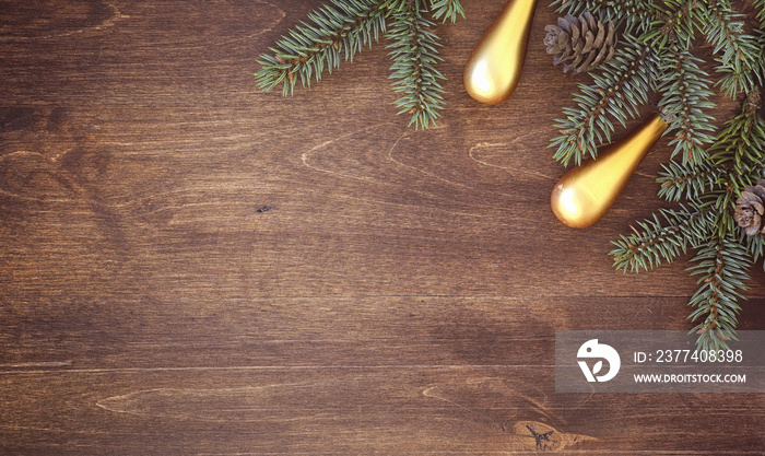 New Years background. Spruce branches on a wooden table. Ornaments for the New Year tree. Christmas