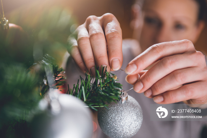 Woman decorating christmas tree