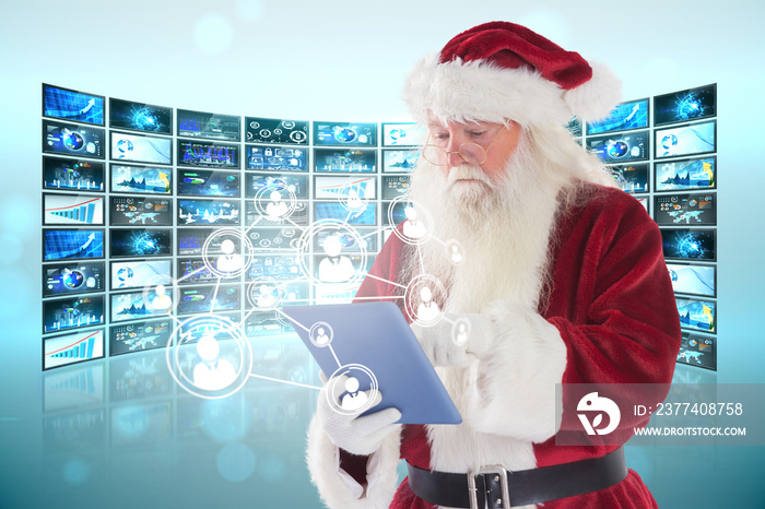 Santa uses a tablet PC against screen collage showing business images