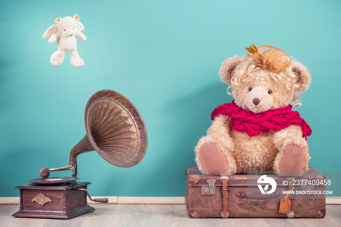 Antique gramophone phonograph turntable, Teddy Bear toy sitting on old luggage and flying bear with 