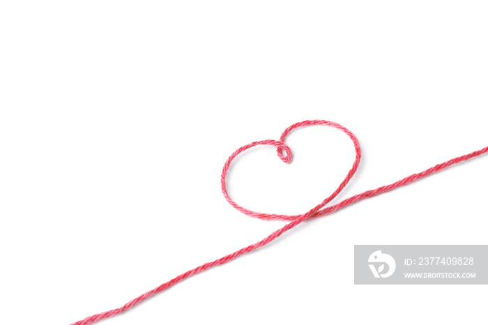 Red thread and heart isolated on white background