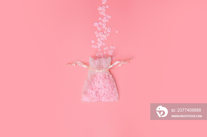 Organza bags on pink background texture with beautiful flowers coming out, white Daisies, Spring,Mot