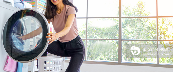 close ups arrogant Asian girl taking clothes out of the washing machine