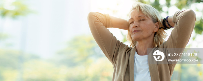 Portrait of happy senior woman relax in park