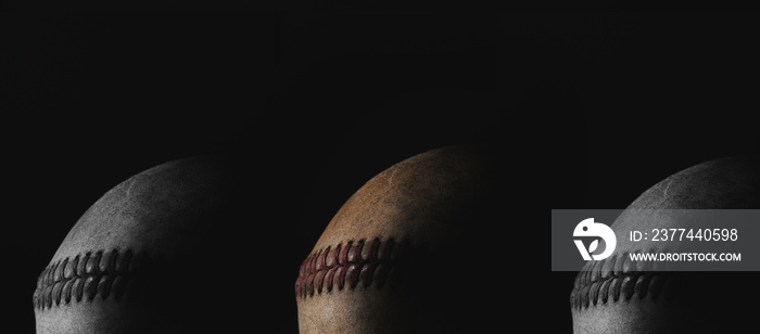 Low key lighting with old used baseball balls on black banner background.