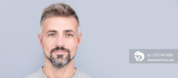 mature handsome man portrait with grizzled beard hair, male beauty. Man face portrait, banner with copy space.