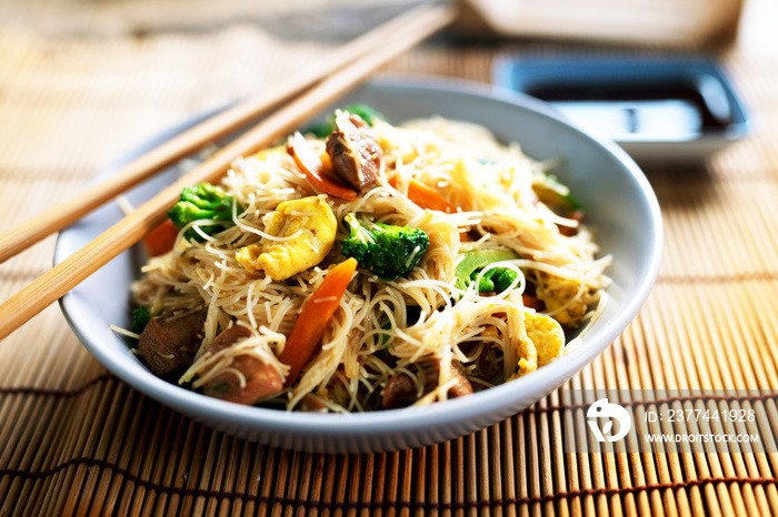 Asian rice noodles wok with chicken and vegetables