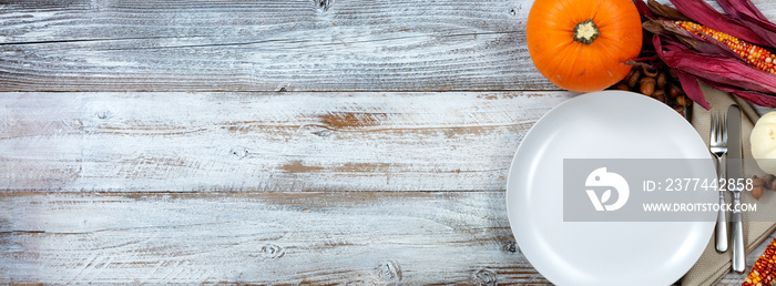 White dinner table decorated for Thanksgiving celebration with plenty of copy space