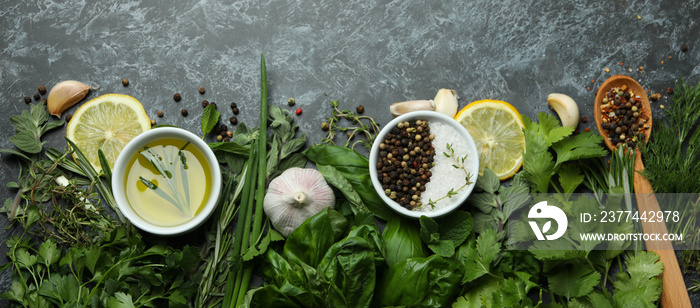 Fresh herbs on black smokey background, top view